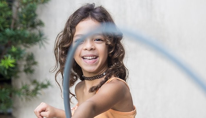 Young girl playing with hula hoop