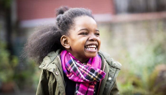 Young girl smiling outdoors