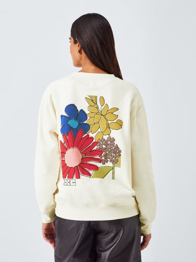 Cream coloured sweatshirt with wildflower print on the back