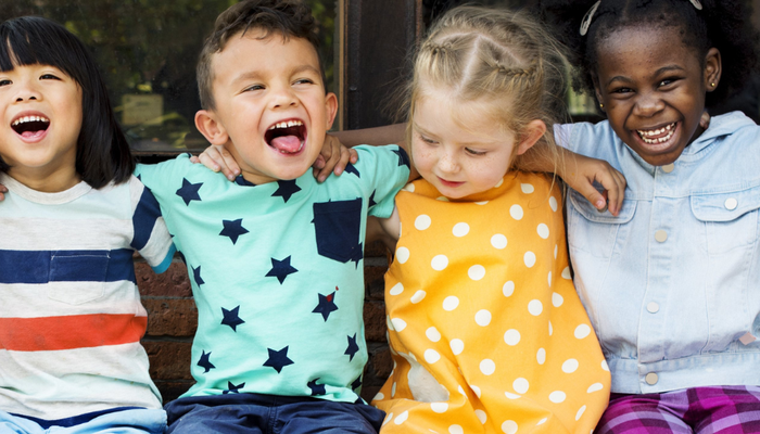 Group of young children smiling and laughing