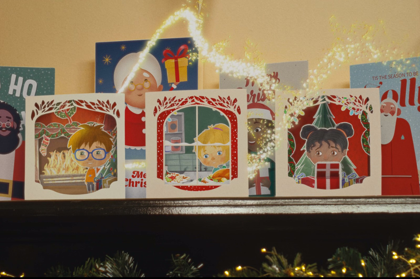 Secret Santa Christmas TV ad Festive mantlepiece with Christmas cards showing ilutrations of three happy children