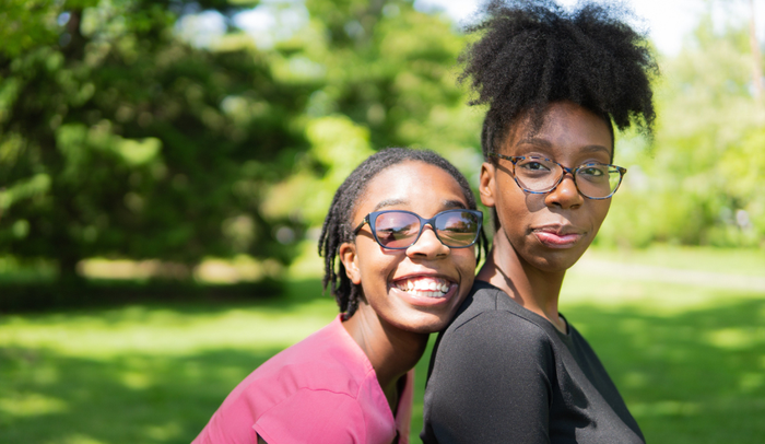 Two smiling sisters in garden