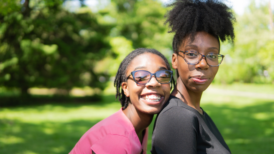 Two smiling sisters in garden
